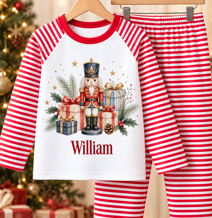 Personalised red and white striped kids Christmas pyjamas with Nutcracker and Presents design and a custom name printed on the front