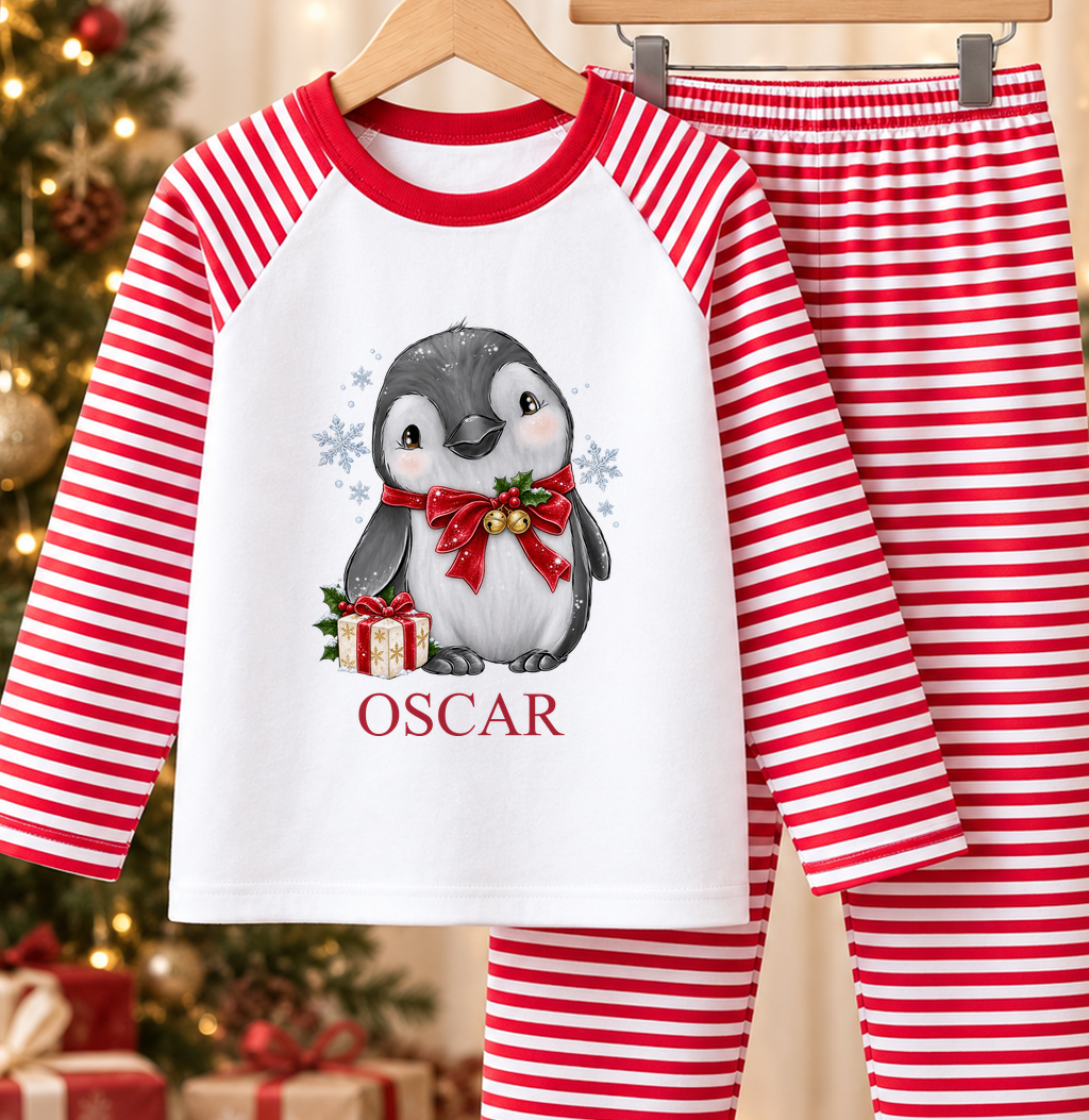 Personalised red and white striped kids Christmas pyjamas with Jingle Bell Penguin design and a custom name printed on the front
