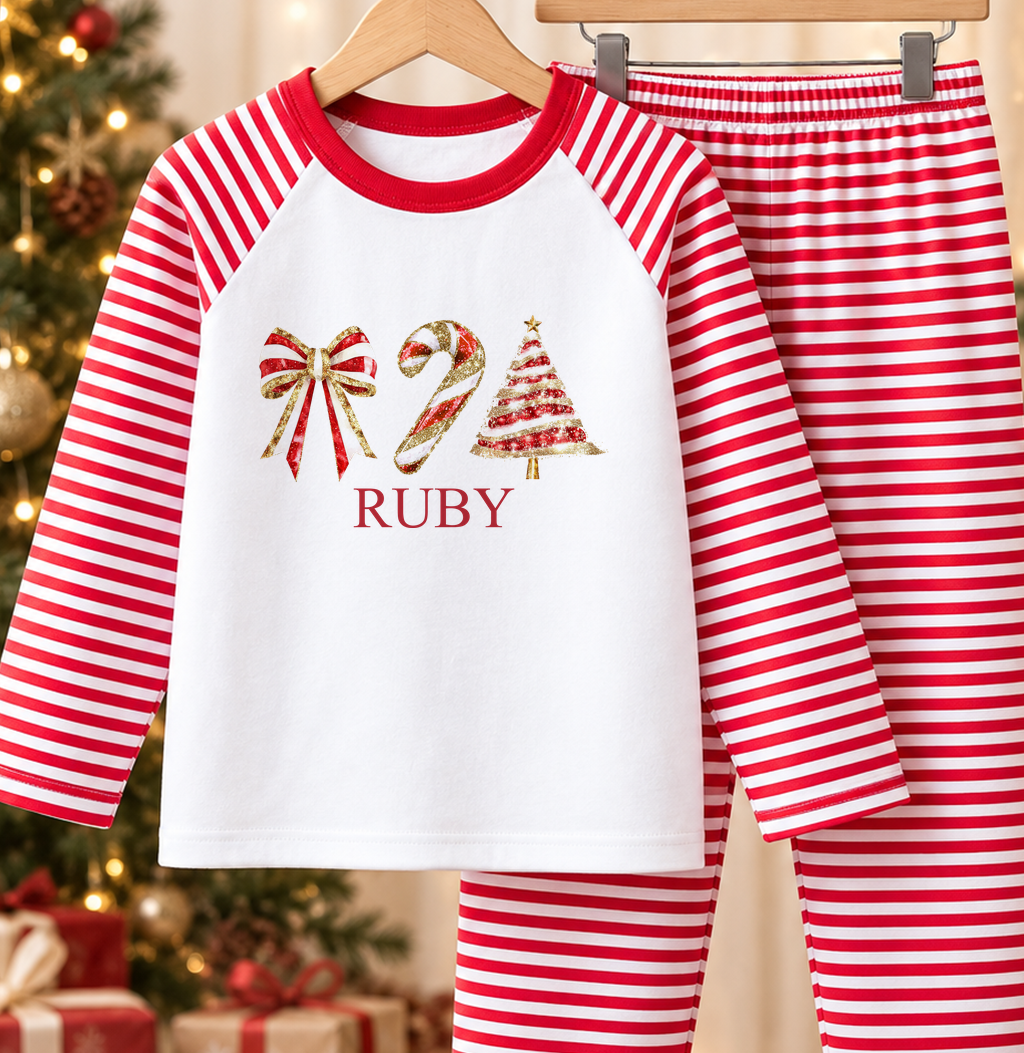 Personalised red and white striped kids Christmas pyjamas with Bow, Candy Cane and Tree design and a custom name printed on the front