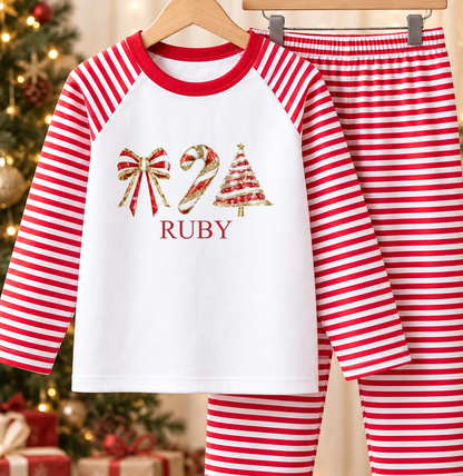 Personalised red and white striped kids Christmas pyjamas with Bow, Candy Cane and Tree design and a custom name printed on the front