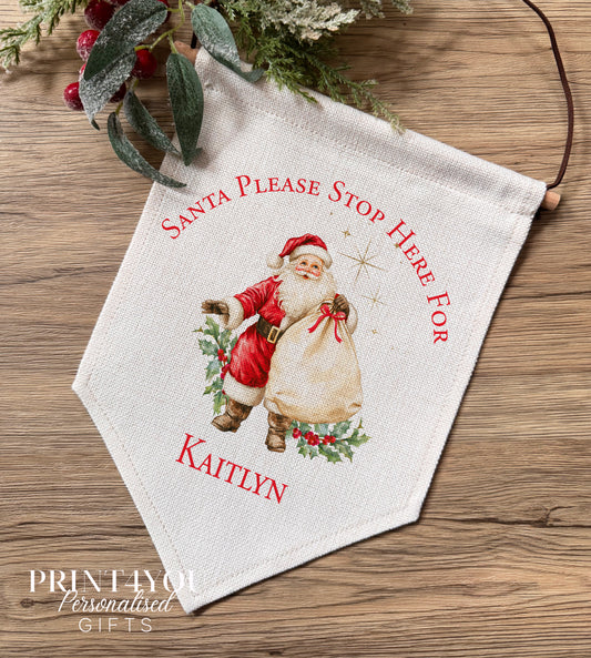 Personalised linen Christmas banner featuring a classic Father Christmas design, personalised with the name Oliver, hung on a wooden bar