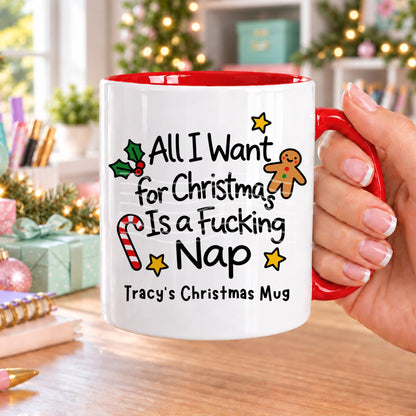 Red handled personalised funny Christmas mug printed with “All I want for Christmas is a f*cking nap” with holly, a gingerbread man, candy cane and stars, and the line “Tracy’s Christmas Mug” underneath