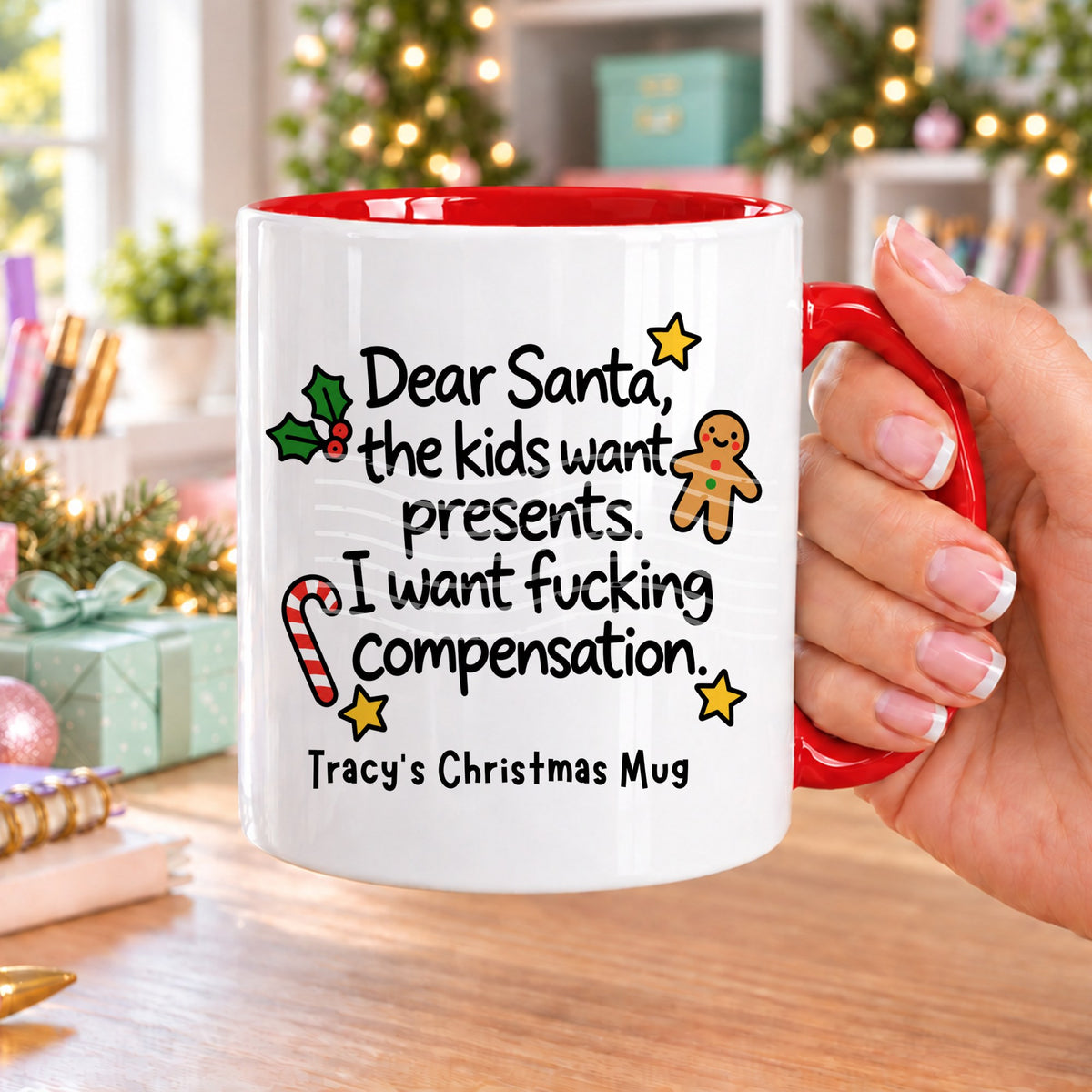 Red handled personalised funny Christmas mug printed with “Dear Santa, the kids want presents. I want f*cking compensation.” with holly, a gingerbread man, candy cane and stars, and the line “Tracy’s Christmas Mug” underneath