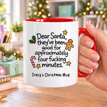 Red handled personalised funny Christmas mug printed with “Dear Santa, they’ve been good for approximately four f*cking minutes.” with holly, a gingerbread man, candy cane and stars, and the line “Tracy’s Christmas Mug” underneath