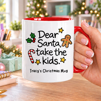 Red handled personalised funny Christmas mug printed with “Dear Santa, take the kids.” with holly, a gingerbread man, candy cane and stars, and the line “Tracy’s Christmas Mug” underneath