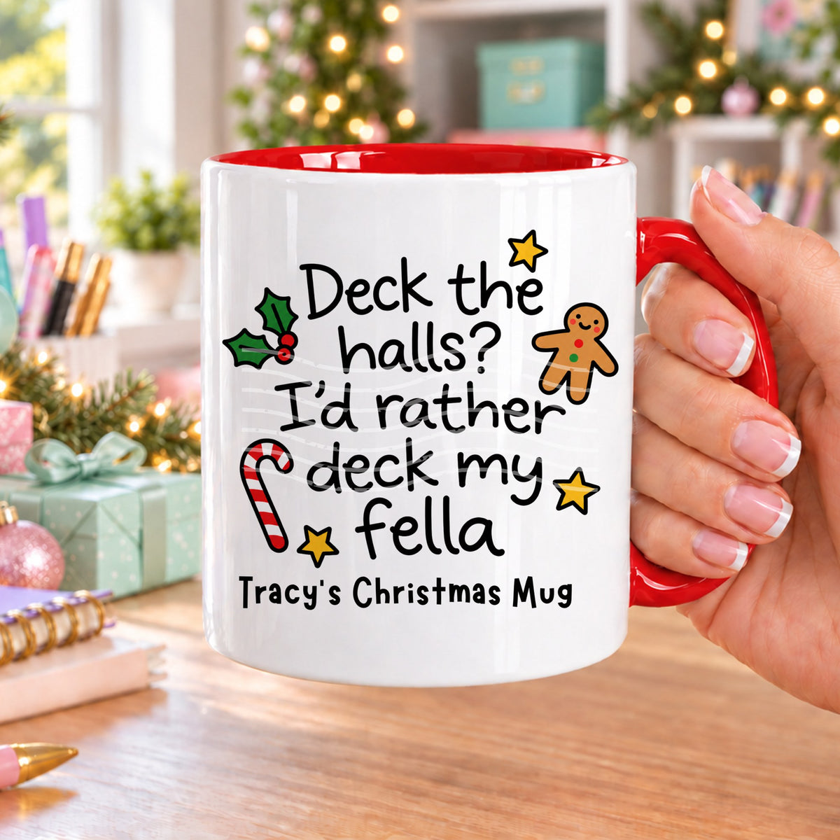 Red handled personalised funny Christmas mug printed with “Deck the halls? I’d rather deck my fella” with holly, a gingerbread man, candy cane and stars, and the line “Tracy’s Christmas Mug” underneath