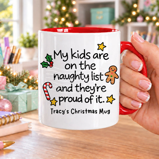 Red handled personalised funny Christmas mug printed with “My kids are on the naughty list and they’re proud of it.” with holly, a gingerbread man, candy cane and stars, and the line “Tracy’s Christmas Mug” underneath