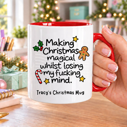 Red handled personalised funny Christmas mug printed with “Making Christmas magical whilst losing my f*cking mind.” with holly, a gingerbread man, candy cane and stars, and the line “Tracy’s Christmas Mug” underneath