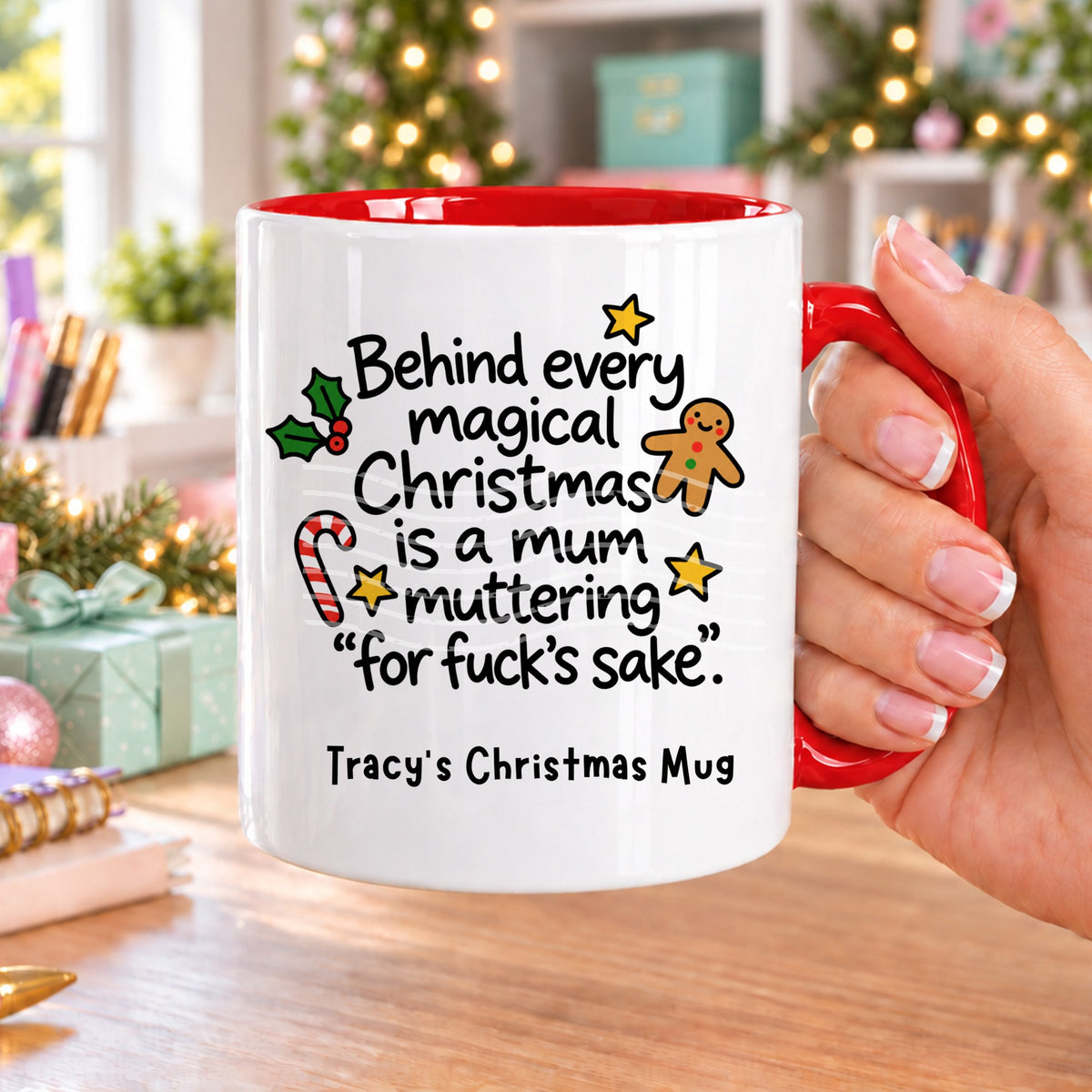 Red handled personalised funny Christmas mug printed with “Behind every magical Christmas is a mum muttering ‘for f*ck’s sake’.” with holly, a gingerbread man, candy cane and stars, and the line “Tracy’s Christmas Mug” underneath