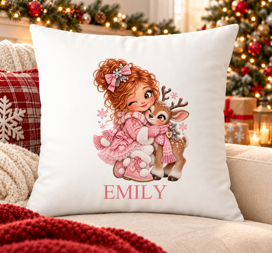 Personalised white Christmas cushion with a girl in pink coat hugging a baby reindeer and a name printed underneath, on a festive sofa
