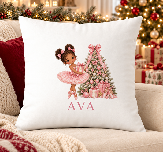 Personalised white Christmas cushion with a curly-haired ballerina in a pink tutu beside a pink Christmas tree and a name printed underneath, on a festive sofa