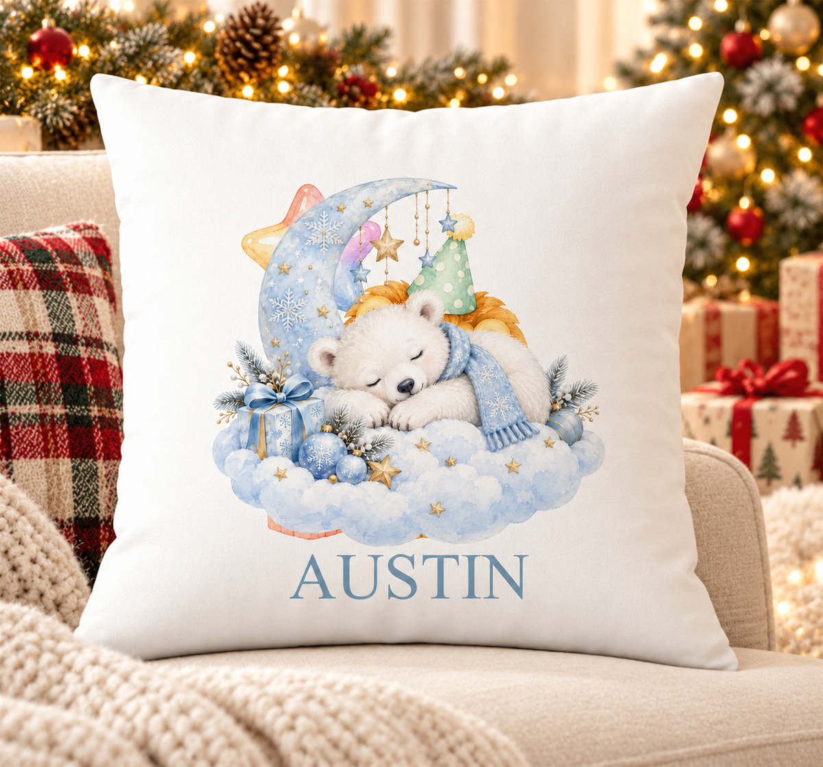 Personalised white Christmas cushion with a sleepy polar bear cub on a cloud under a crescent moon and a name printed underneath, on a festive sofa