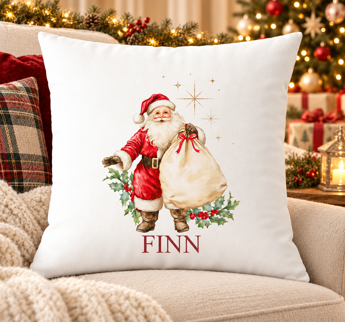 Personalised white Christmas cushion with a traditional Father Christmas carrying a sack of toys and a name printed underneath, on a festive sofa