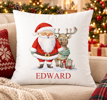 Personalised white Christmas cushion with a jolly Santa standing with his reindeer and a name printed underneath, on a festive sofa
