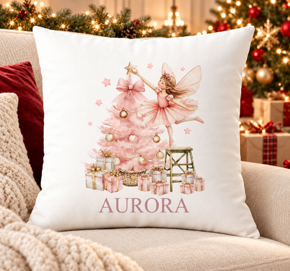 Personalised white Christmas cushion with a sugar plum fairy decorating a pink Christmas tree and a name printed underneath, on a festive sofa