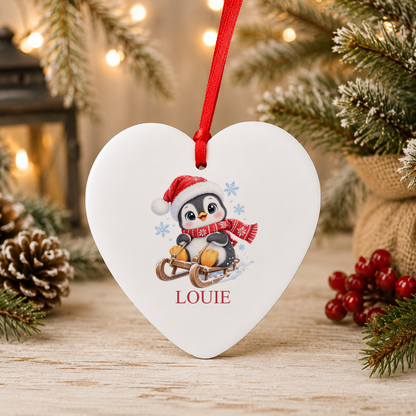 Personalised Sledging Penguin Christmas heart decoration with a custom name