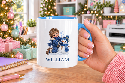 Personalised Boy Building Snowman Christmas mug – blue handle with a custom name