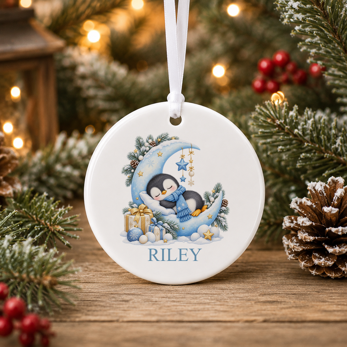 Personalised Sleepy Penguin Moon Christmas bauble with a custom name