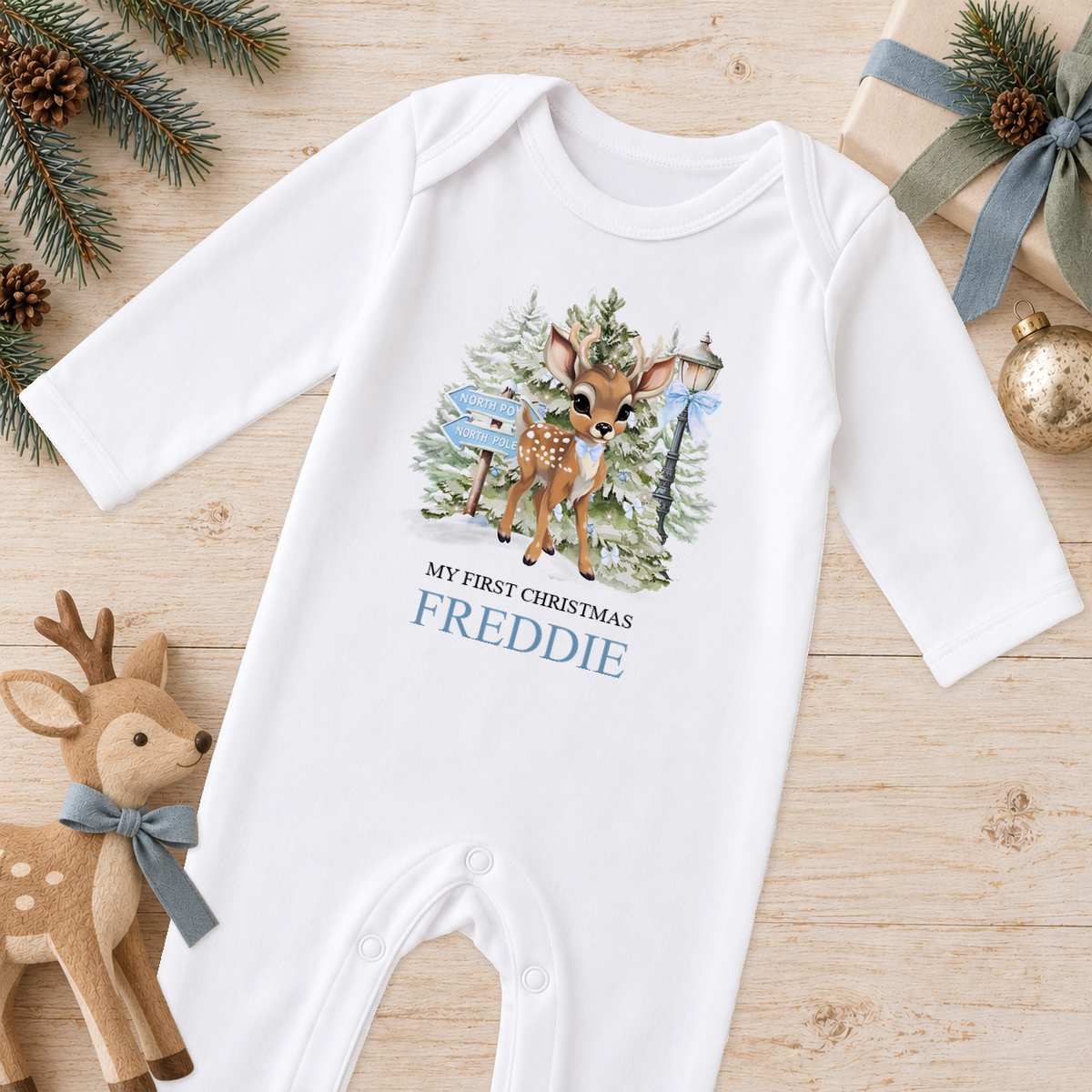 Personalised North Pole Fawn Blue Bow baby Christmas sleepsuit with a custom name