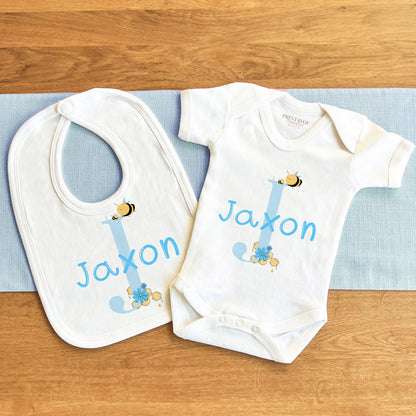 Personalised blue alphabet bumblebee bodysuit with baby's name printed on the front in soft cotton.