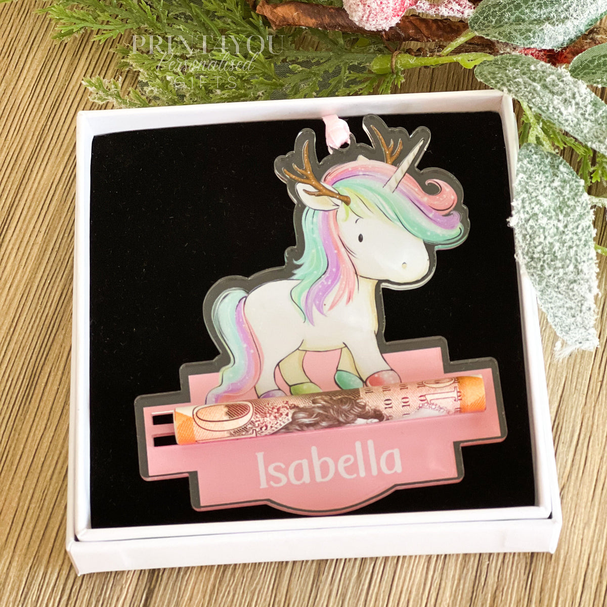Close-up of the personalised unicorn reindeer acrylic Christmas tree ornament showing the custom name printed on the front