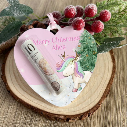 Personalised heart-shaped acrylic money holder with a unicorn reindeer design and custom name, hanging by a ribbon