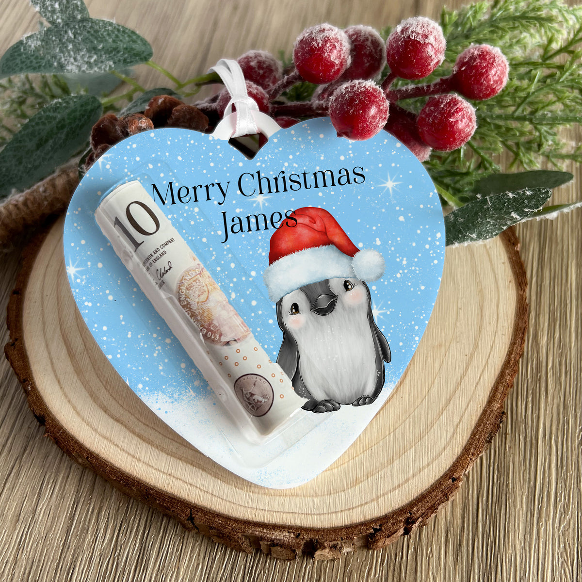 Personalised teddy bear heart money holder hanging on a Christmas tree branch