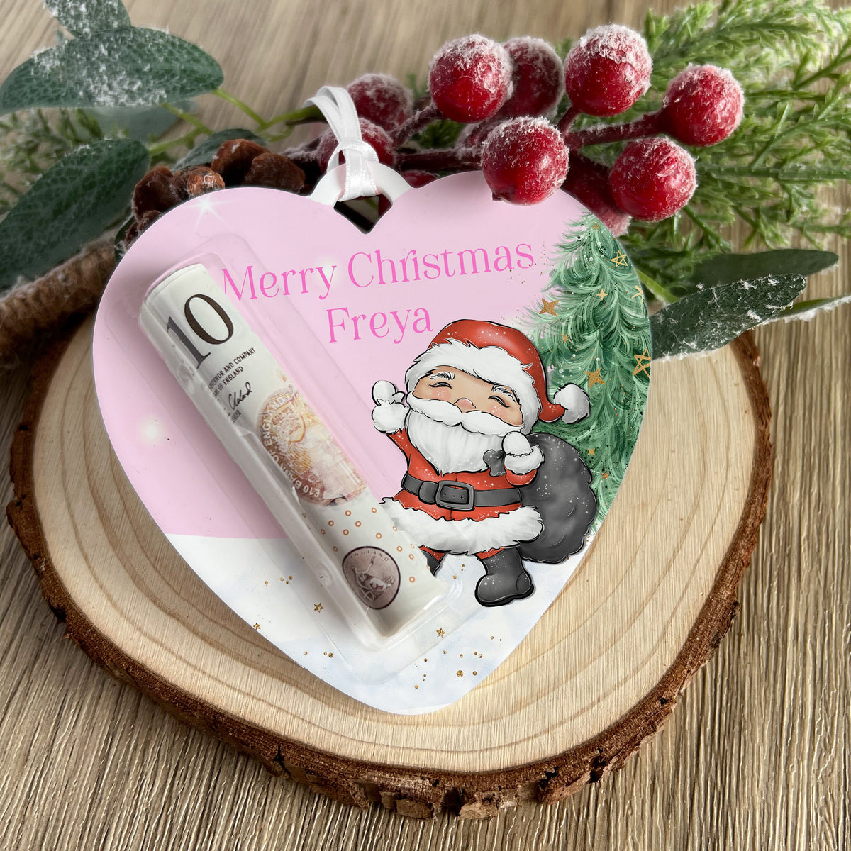 Personalised pink reindeer heart money holder hanging on a Christmas tree branch