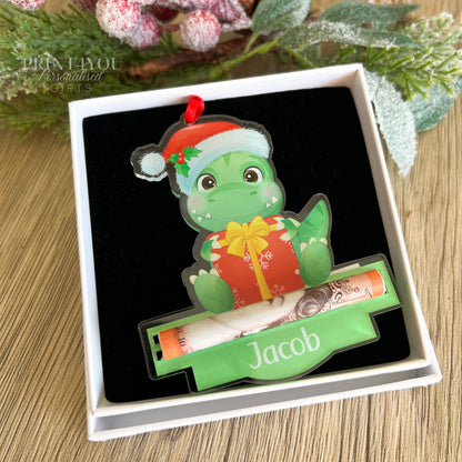 Close-up of the personalised dinosaur acrylic Christmas tree ornament showing the custom name printed on the front