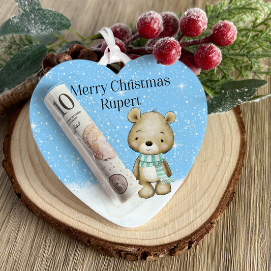 Personalised heart-shaped acrylic money holder with a teddy bear heart design and custom name, hanging by a ribbon