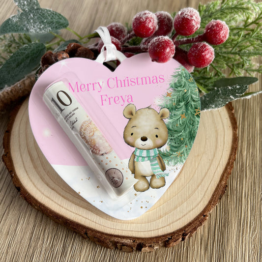 Personalised acrylic Christmas money holder in a Pink Teddy Bear Heart design, printed with a name and hung with a ribbon