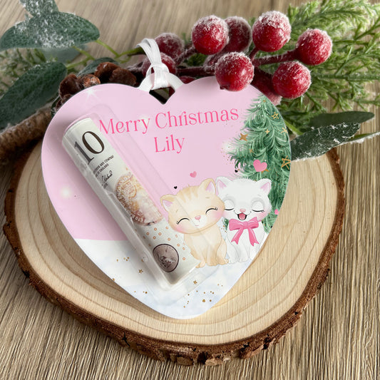 Personalised heart-shaped acrylic money holder with a pink kittens design and custom name, hanging by a ribbon