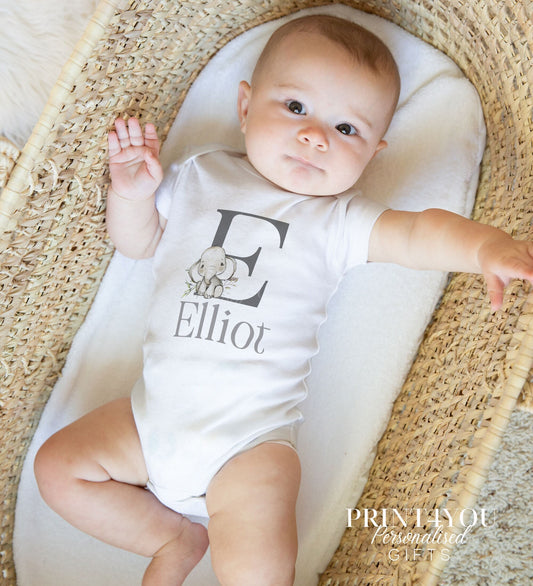 Personalised safari elephant alphabet bib laid flat, printed with an alphabet letter and the baby's name.