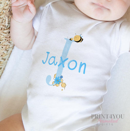 Personalised bib in soft white cotton printed with the blue alphabet and bumblebee design and baby's name.