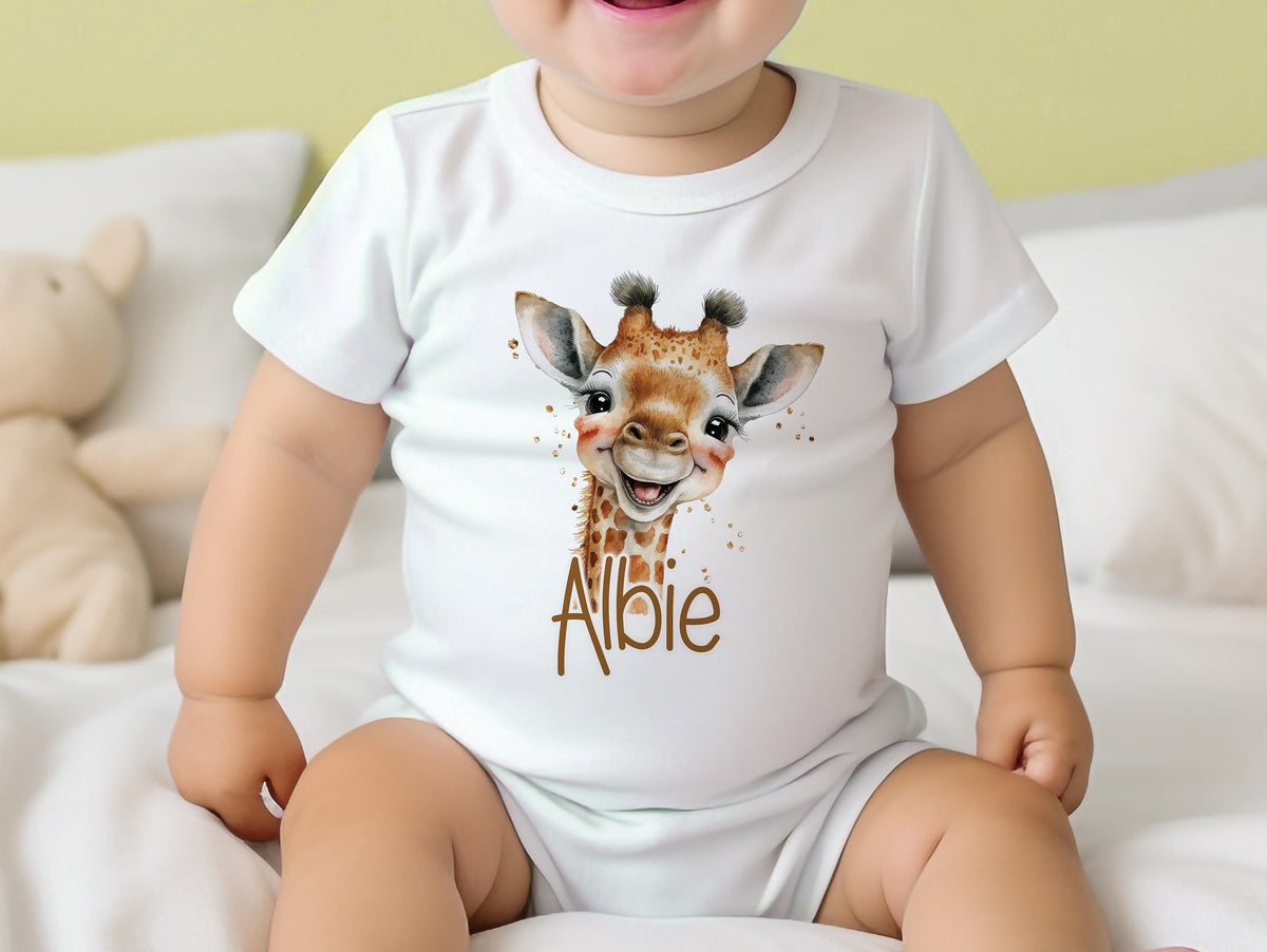 Personalised safari giraffe new baby gift set styled together, showing the bib, vest and sleepsuit.