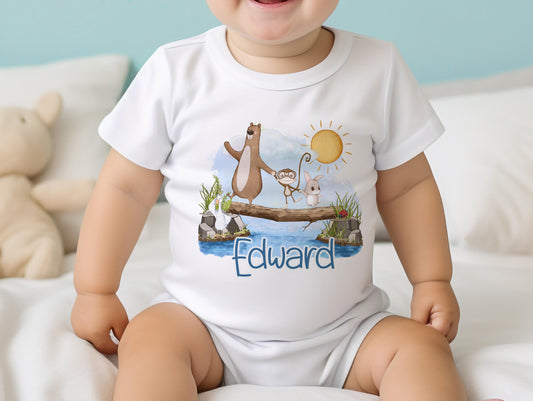 Personalised new baby bib printed with the animals on a log design and the baby's name.
