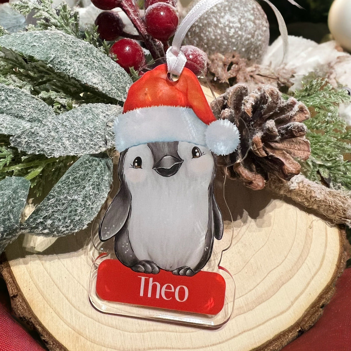 Close-up of the Penguin design printed on the clear acrylic Christmas bauble