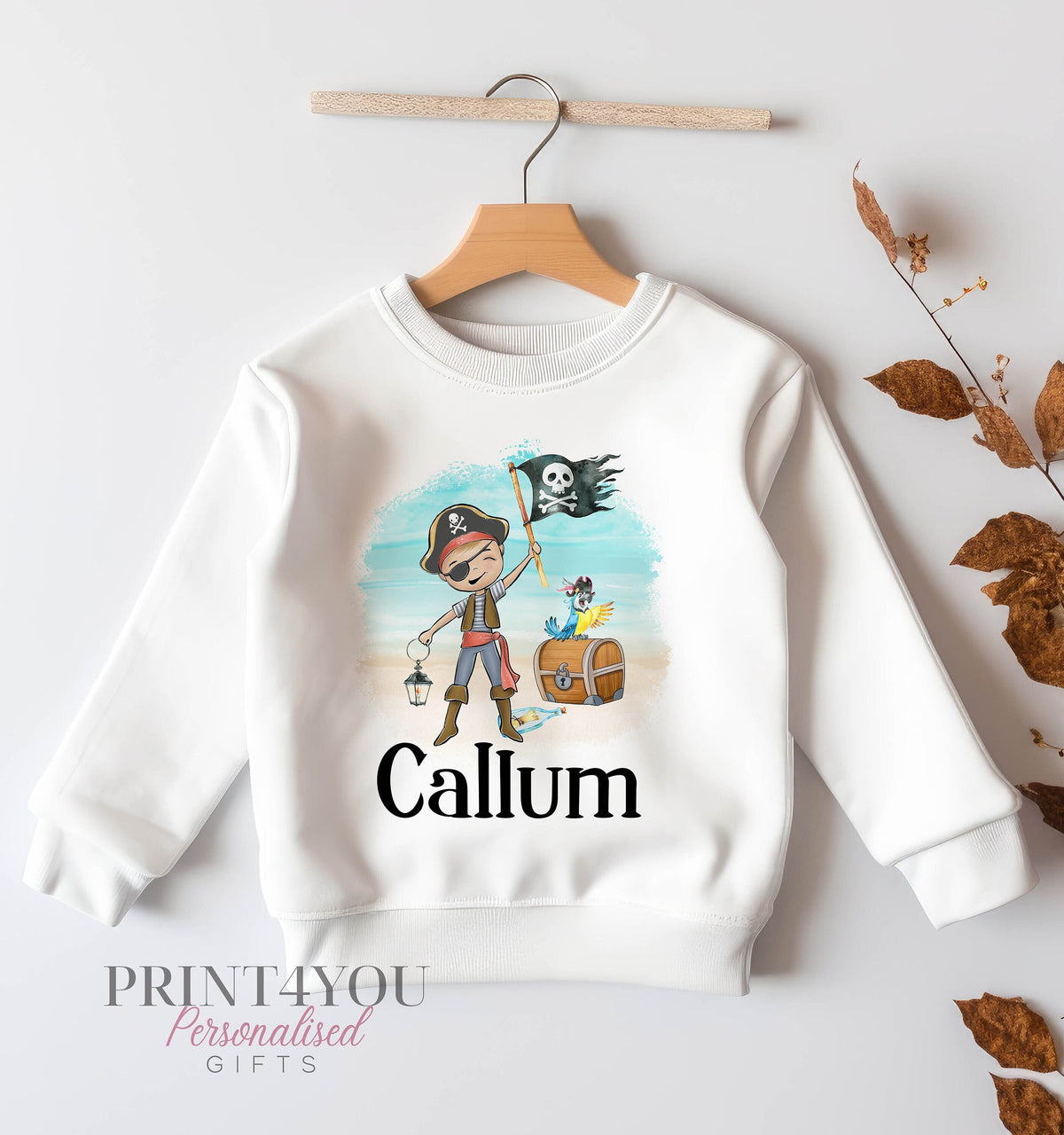 White children's sweatshirt printed with a cartoon pirate boy holding a skull and crossbones flag, a parrot and a treasure chest, personalised with the name Callum