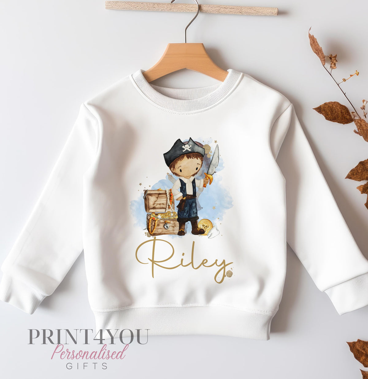 White cotton kids sweatshirt printed with a pirate boy design and treasure chest, personalised with the name Riley