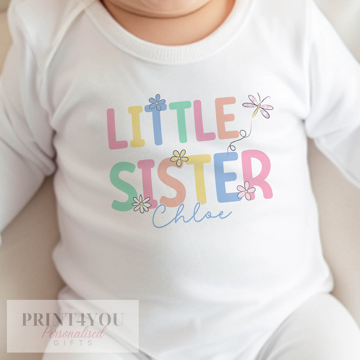 Personalised 'Little Sister' sleepsuit in soft white cotton, printed with baby's name for a new baby announcement.